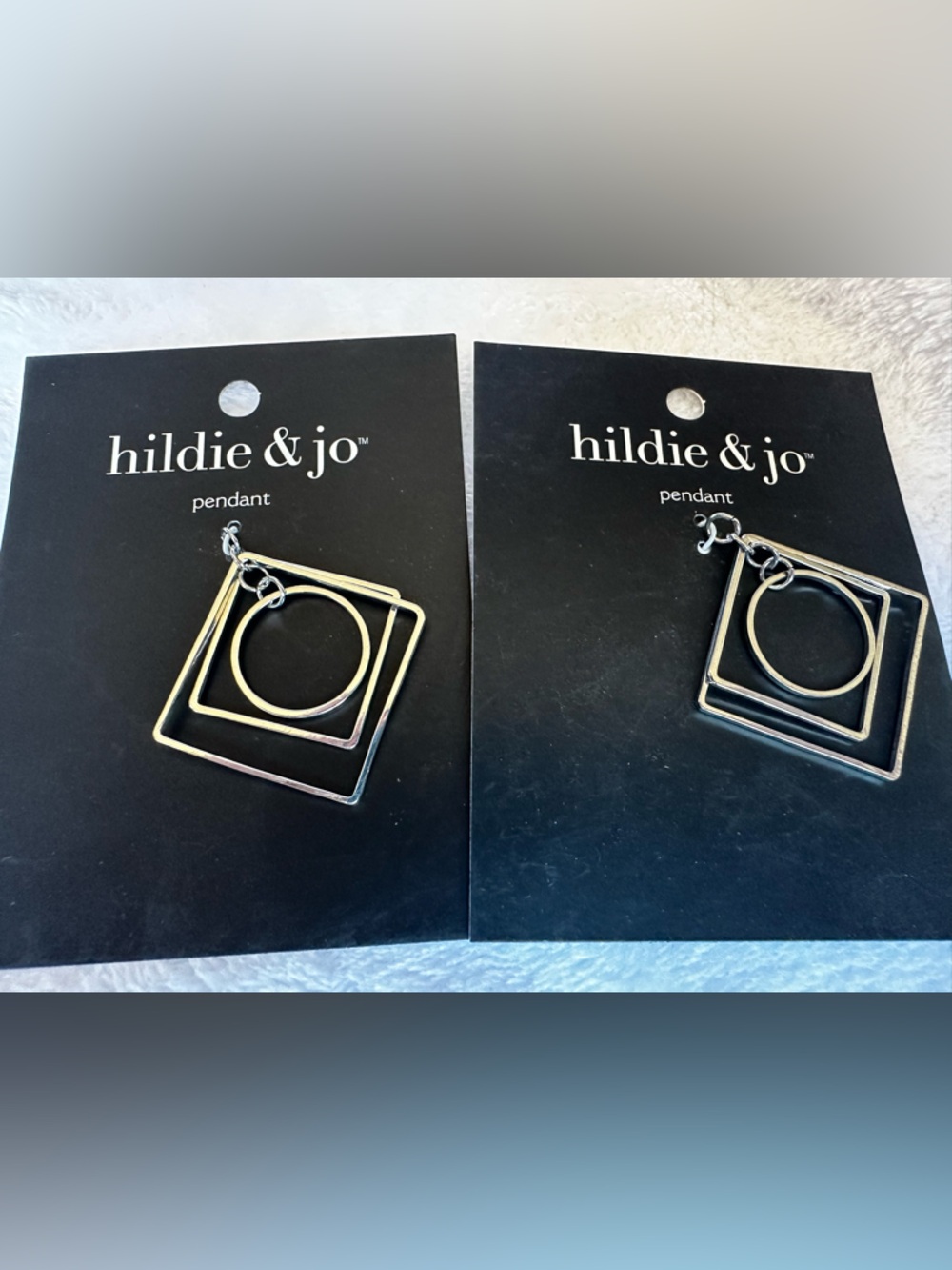 Set of two Silvertone Hildie and Jo Pendants